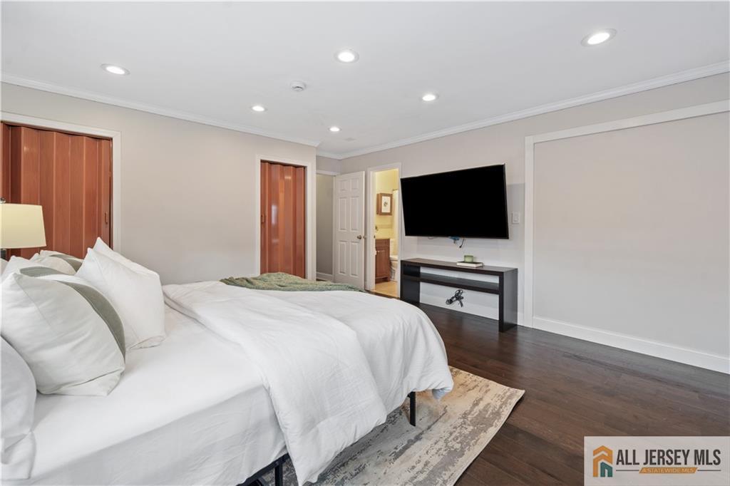 35 Emerald Road Kendall Park, NJ 08824 - Photo 21 of 37 a bedroom with a bed and a flat screen tv