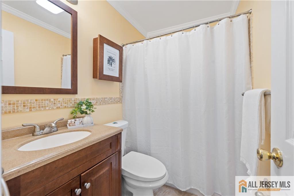 35 Emerald Road Kendall Park, NJ 08824 - Photo 22 of 37 a bathroom with a granite countertop sink and a mirror
