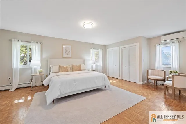 a spacious bedroom with a bed a table and chair