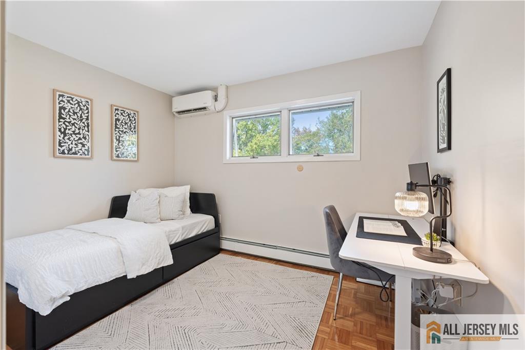 35 Emerald Road Kendall Park, NJ 08824 - Photo 24 of 37 a bedroom with a bed and a table in it