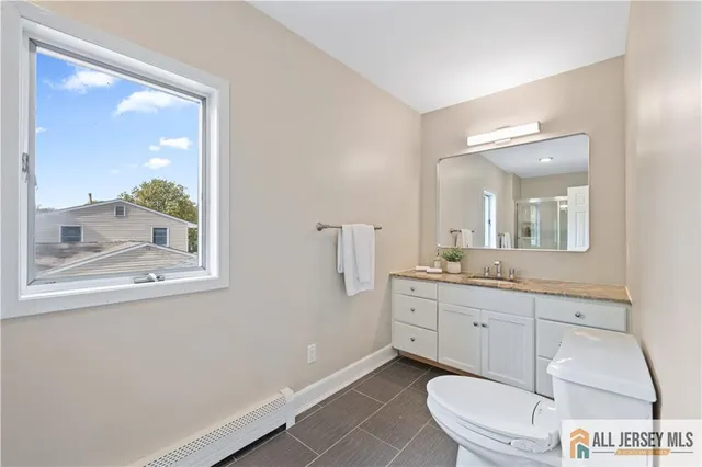a bathroom with a toilet a sink and a mirror