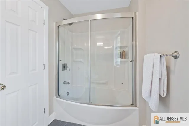 a bathroom with a shower and a tub