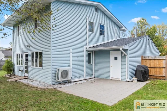 a view of a house with a yard and a garage