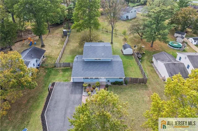 an aerial view of a house with a swimming pool