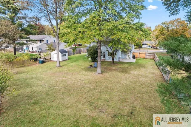 a backyard of a house with barbeque oven table and chairs