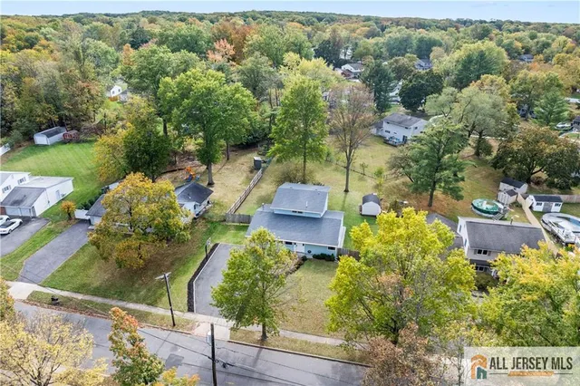 an aerial view of a house with yard
