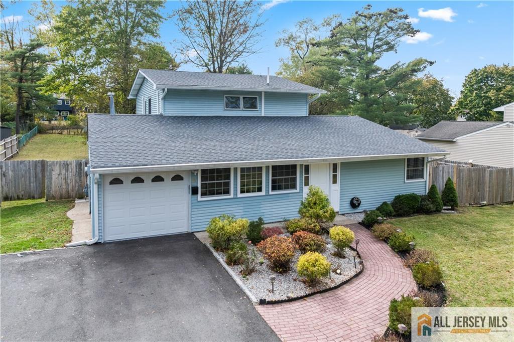 35 Emerald Road Kendall Park, NJ 08824 - Photo 36 of 37 a front view of a house with a yard and outdoor seating