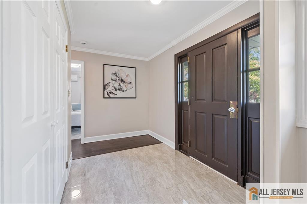 35 Emerald Road Kendall Park, NJ 08824 - Photo 5 of 37 a view of a hallway with wooden floor