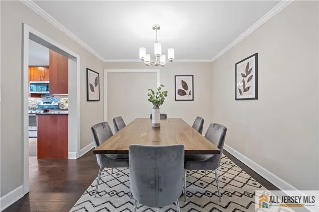 a view of a dining room with furniture wooden floor and a chandelier