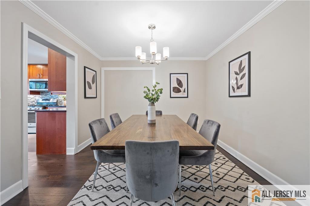 35 Emerald Road Kendall Park, NJ 08824 - Photo 9 of 37 a view of a dining room with furniture wooden floor and a chandelier