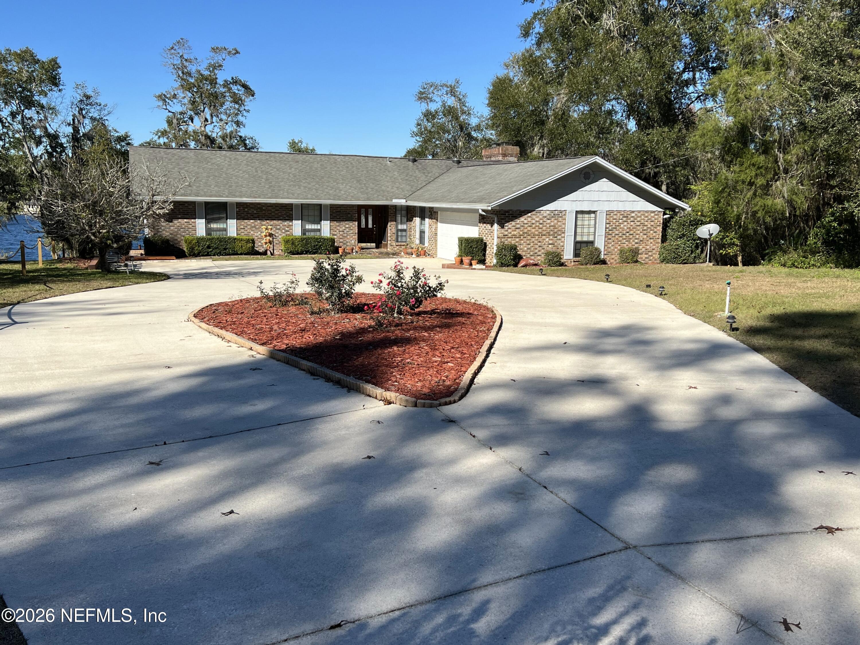 268 Wesley Road Green Cove Springs, FL 32043 - Photo 12 of 84 a front view of a house with garden