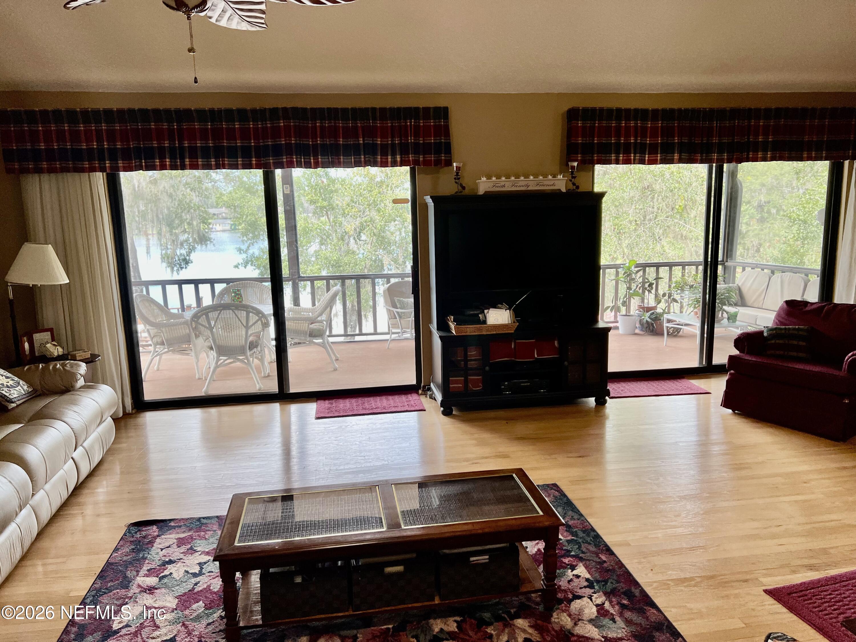 268 Wesley Road Green Cove Springs, FL 32043 - Photo 22 of 84 a living room with furniture fireplace and a flat screen tv