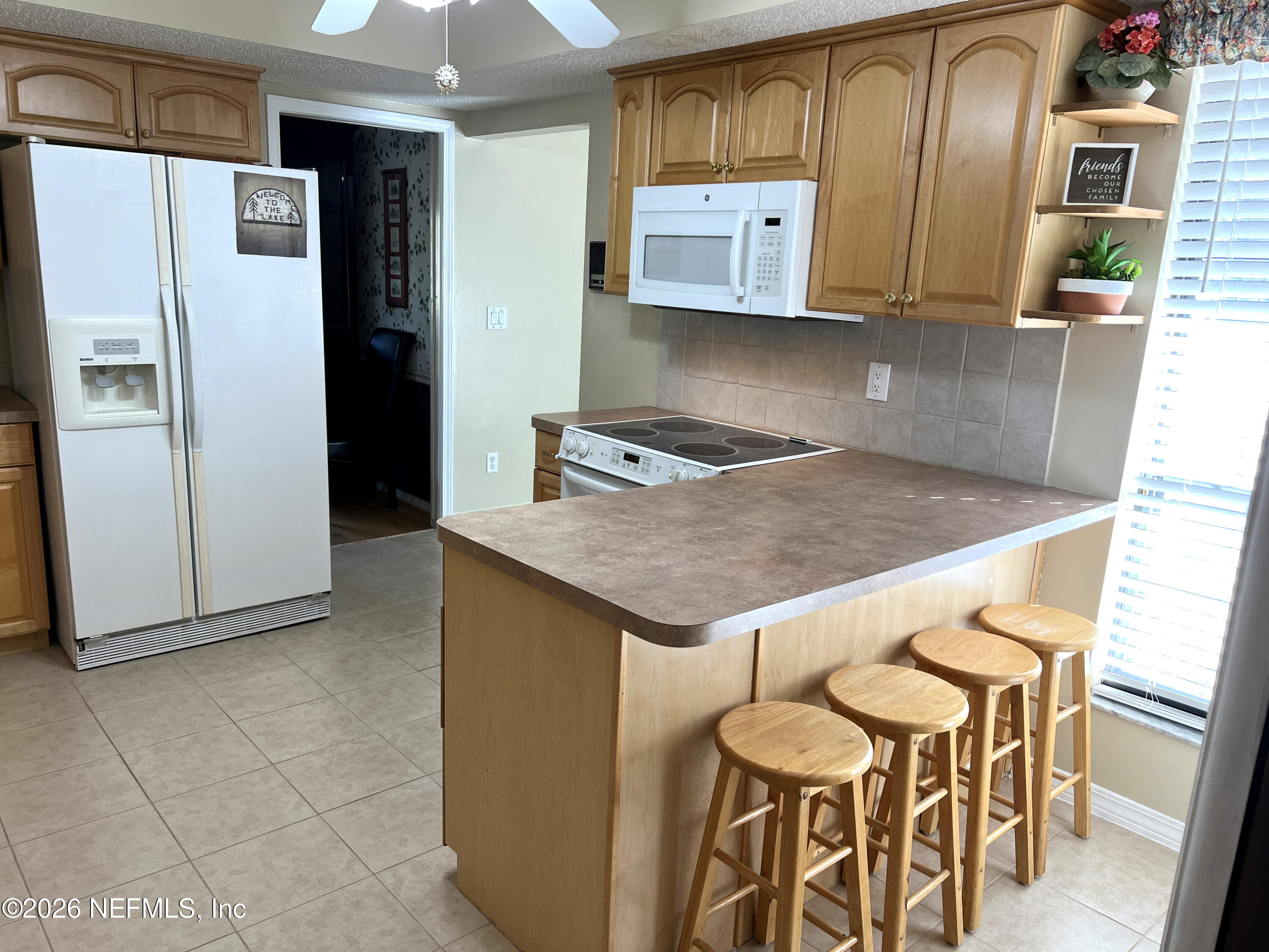 268 Wesley Road Green Cove Springs, FL 32043 - Photo 28 of 84 a kitchen with stainless steel appliances granite countertop a refrigerator and a stove top oven