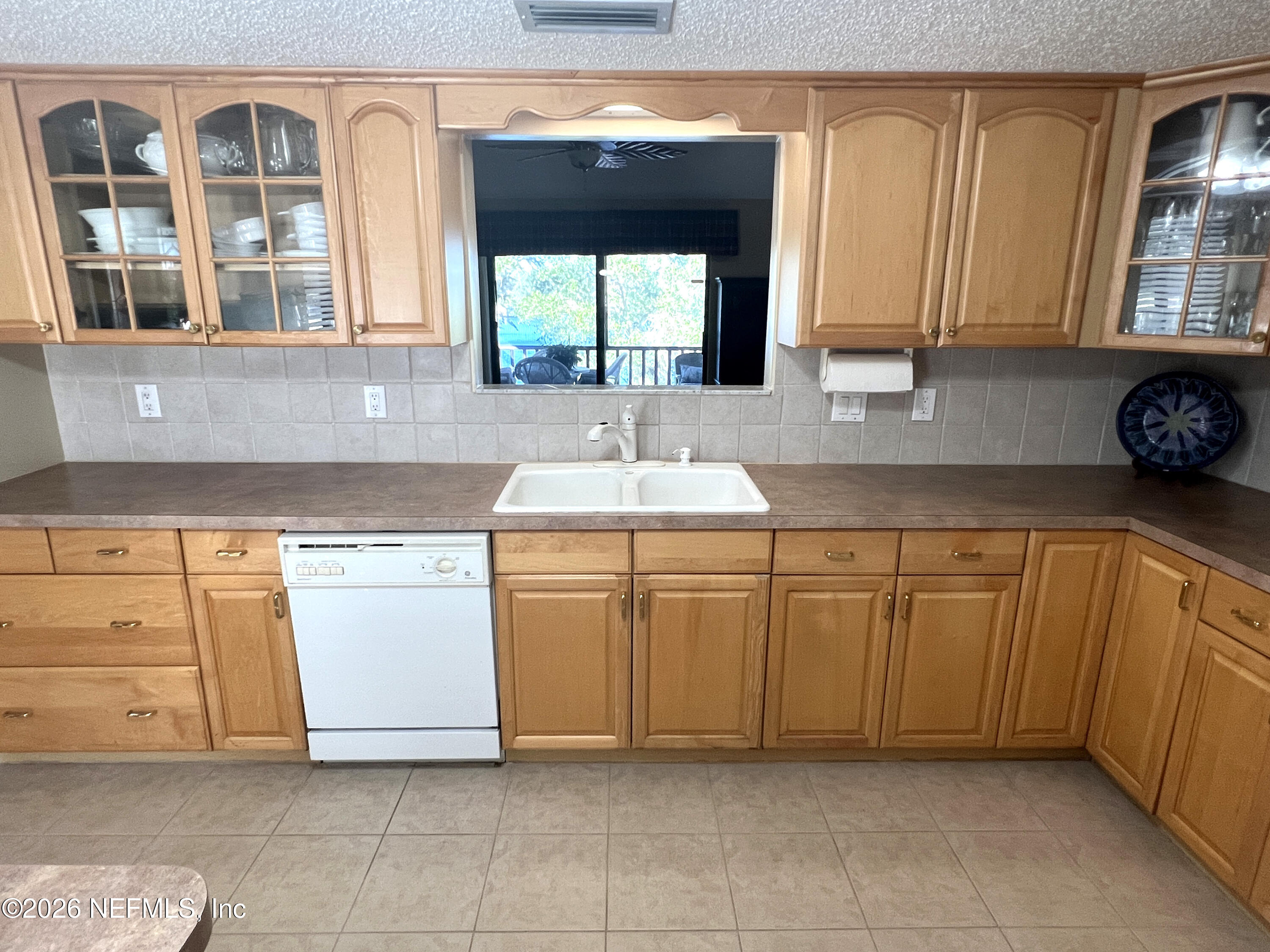 268 Wesley Road Green Cove Springs, FL 32043 - Photo 31 of 84 a kitchen with cabinets and window