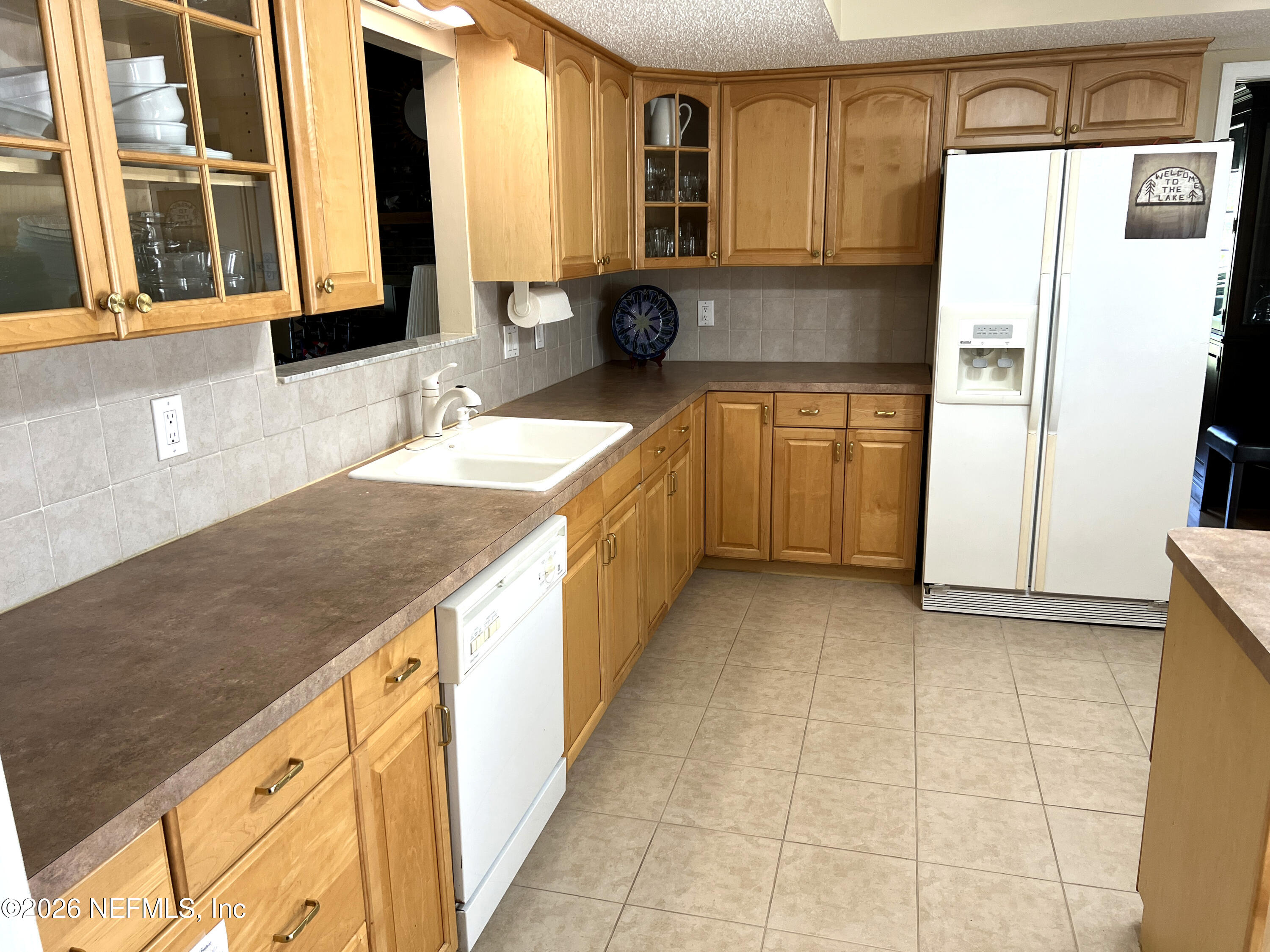 268 Wesley Road Green Cove Springs, FL 32043 - Photo 33 of 84 a kitchen with stainless steel appliances granite countertop a sink and a refrigerator