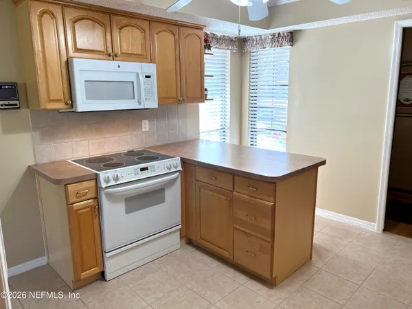 a view of a livingroom with furniture and a large window