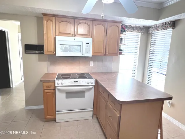 a view of a livingroom with furniture and a large window