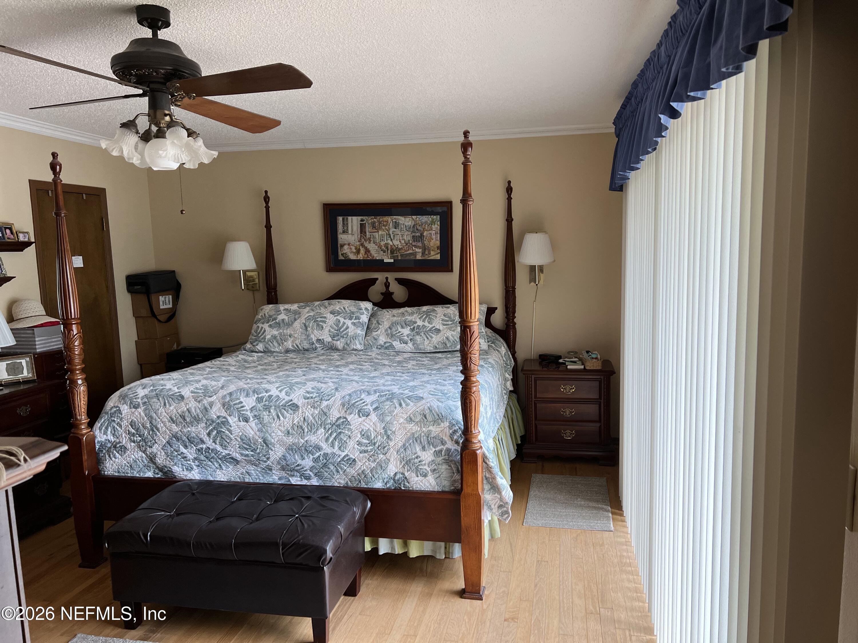 268 Wesley Road Green Cove Springs, FL 32043 - Photo 41 of 84 a bedroom that has a bed and a chandelier