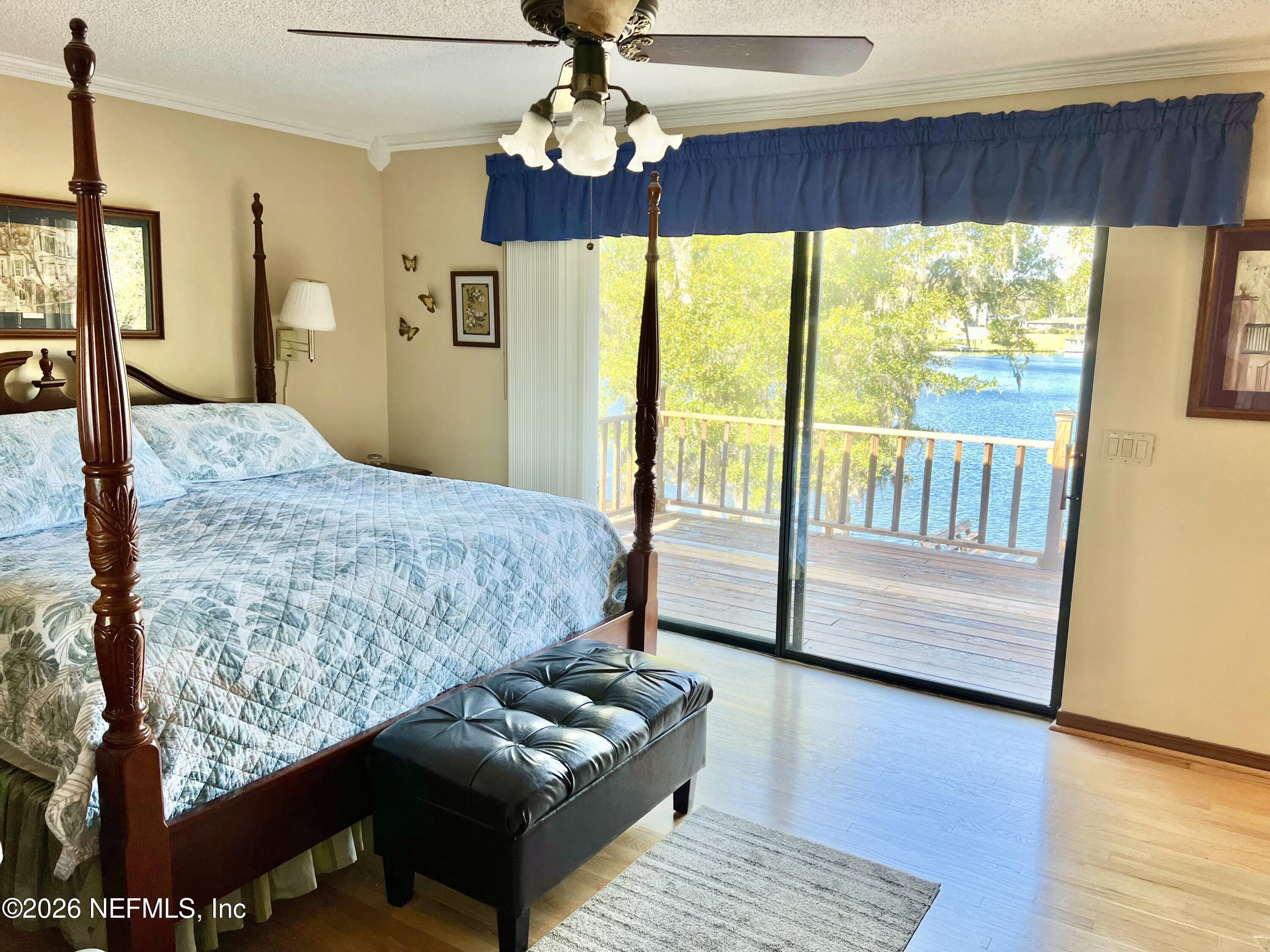 268 Wesley Road Green Cove Springs, FL 32043 - Photo 42 of 84 a bedroom with a bed and wooden floor