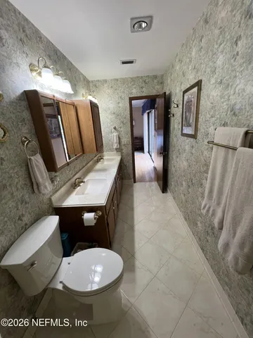 a large kitchen with granite countertop lots of counter space and breakfast area