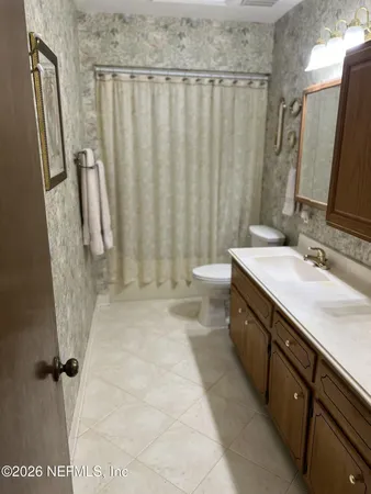 a view of a backyard with large trees