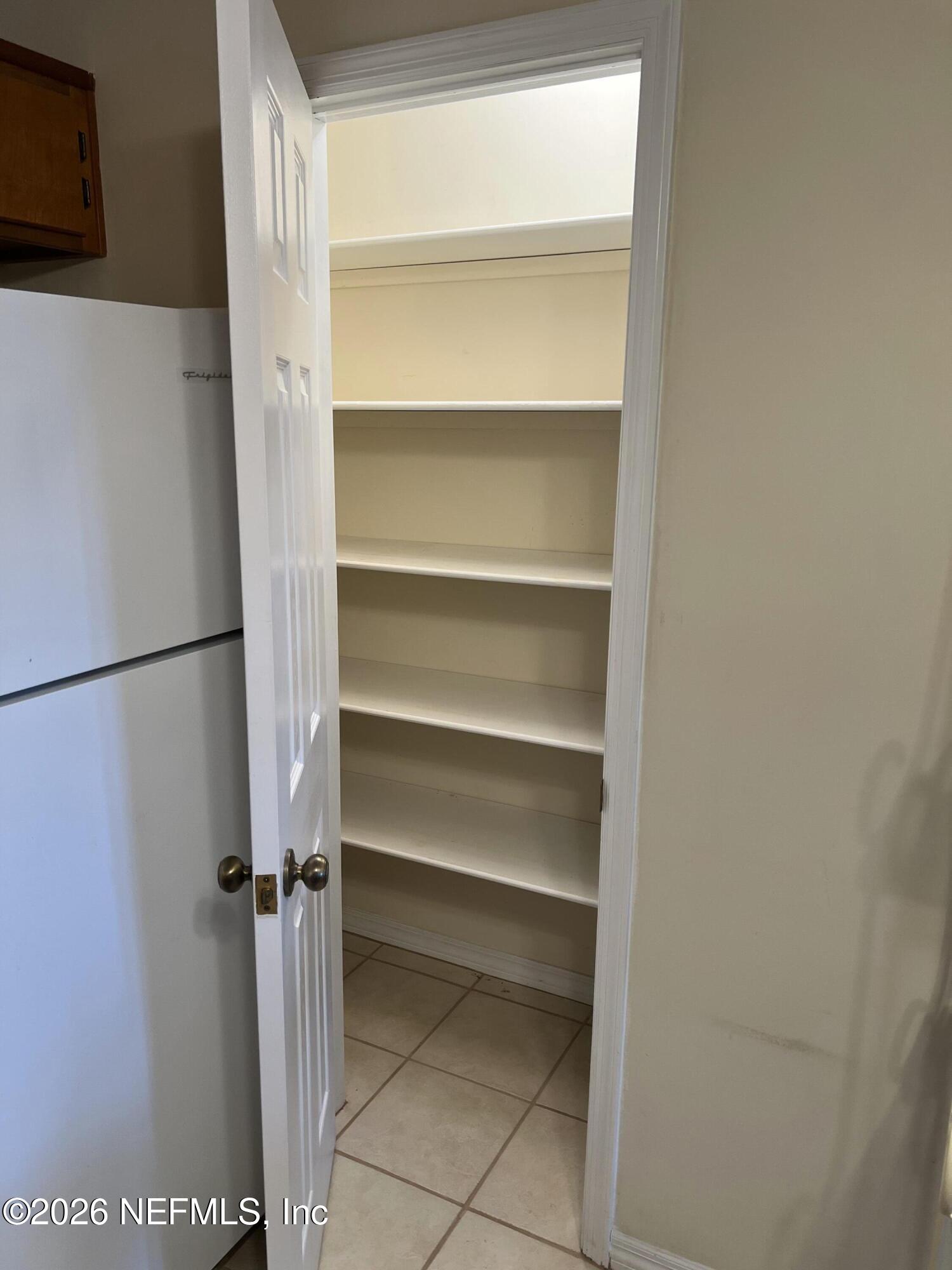 268 Wesley Road Green Cove Springs, FL 32043 - Photo 57 of 84 a view of walk in closet with empty racks