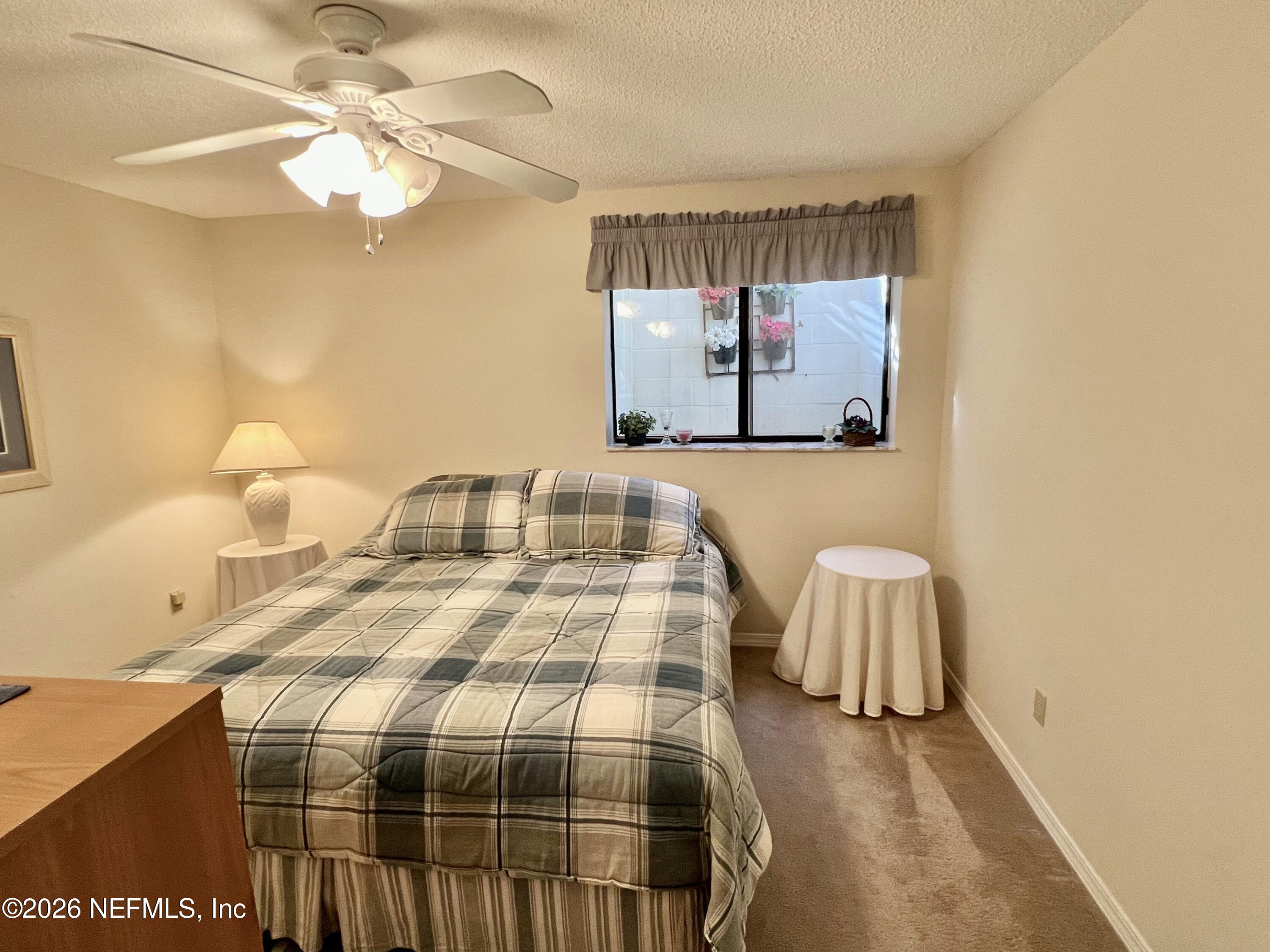 268 Wesley Road Green Cove Springs, FL 32043 - Photo 63 of 84 a bedroom with a bed and lamp