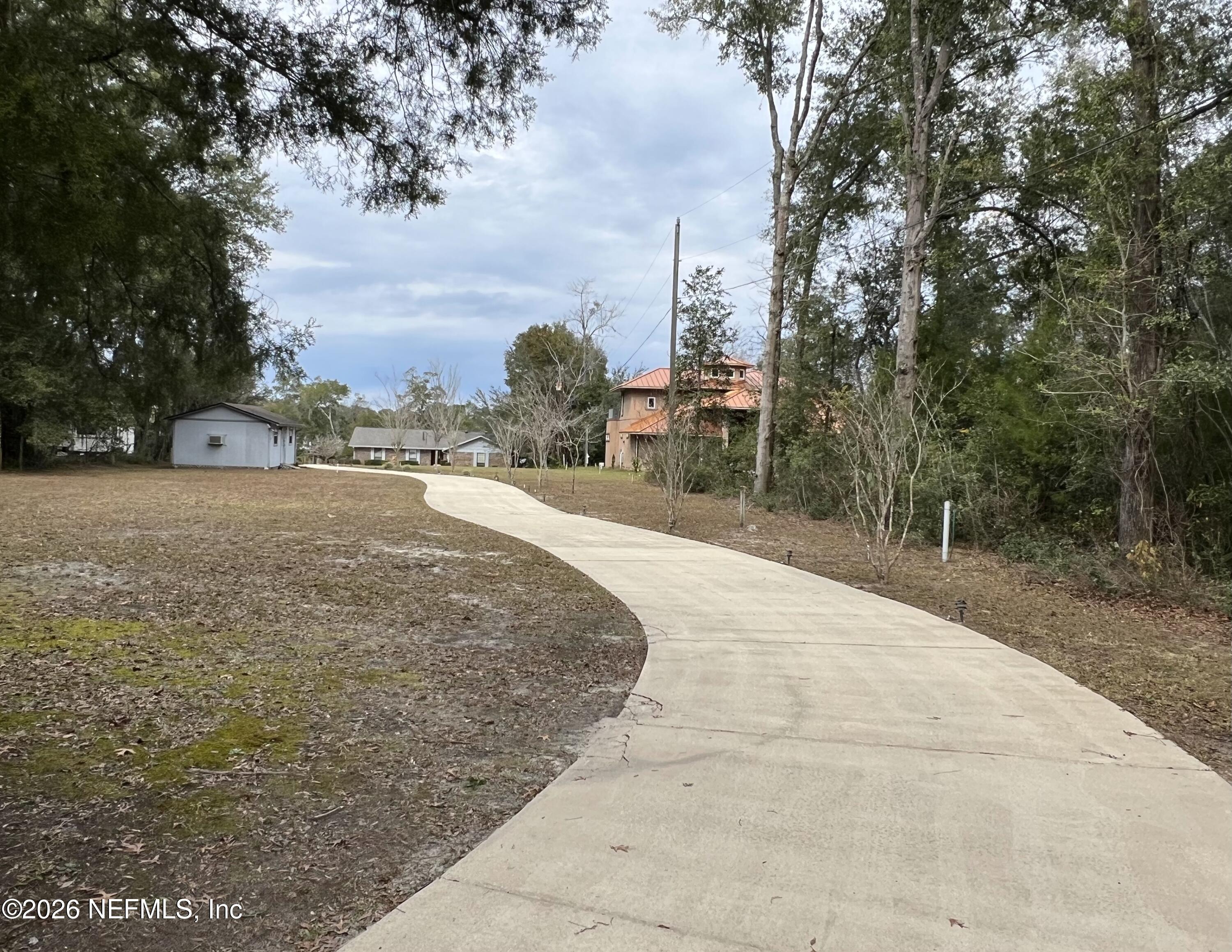 268 Wesley Road Green Cove Springs, FL 32043 - Photo 8 of 84 a pathway of a house with a yard