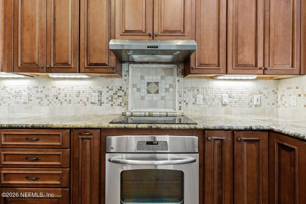 337 South Mill View Way Ponte Vedra Beach, FL 32082 - Photo 16 of 55 a view of a kitchen with granite countertop stainless steel appliances a stove top oven and granite counter space