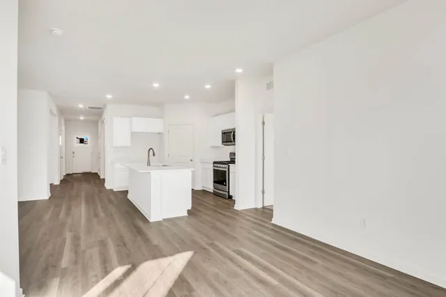 a view of kitchen with wooden floor and electronic appliances