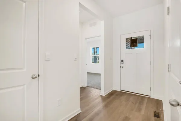 a view of a hallway with wooden floor