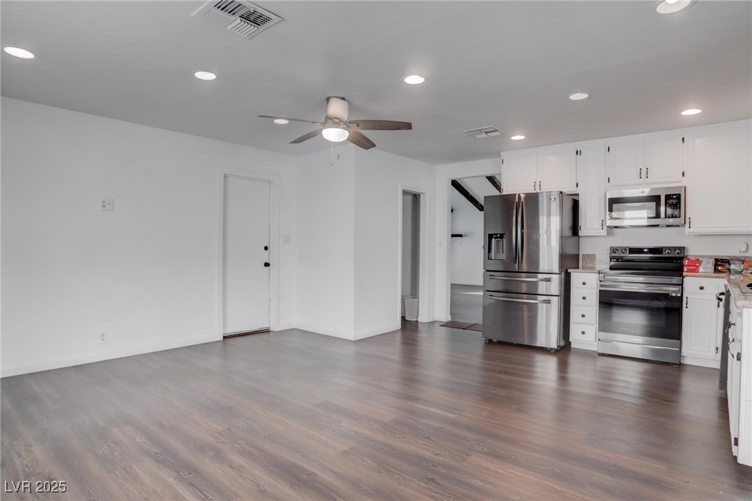 4775 Monaco Road Las Vegas, NV 89121 - Photo 21 of 31 Kitchen featuring appliances with stainless steel finishes, ceiling fan, dark hardwood / wood-style flooring, and white cabinets