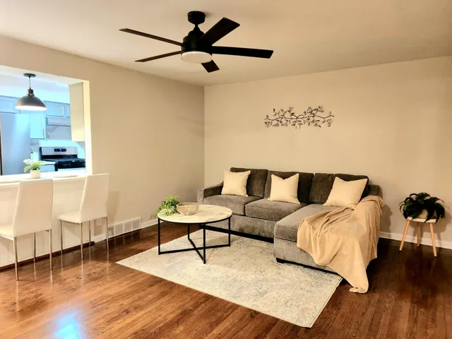 a living room with furniture and a wooden floor
