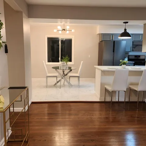 a living room with furniture wooden floor and a table