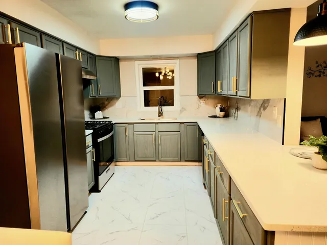 a kitchen with stainless steel appliances granite countertop a sink stove and refrigerator