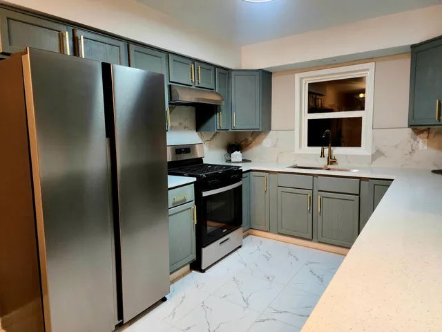 a kitchen with stainless steel appliances a refrigerator stove and sink
