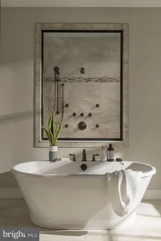 a white bath tub sitting next to a sink