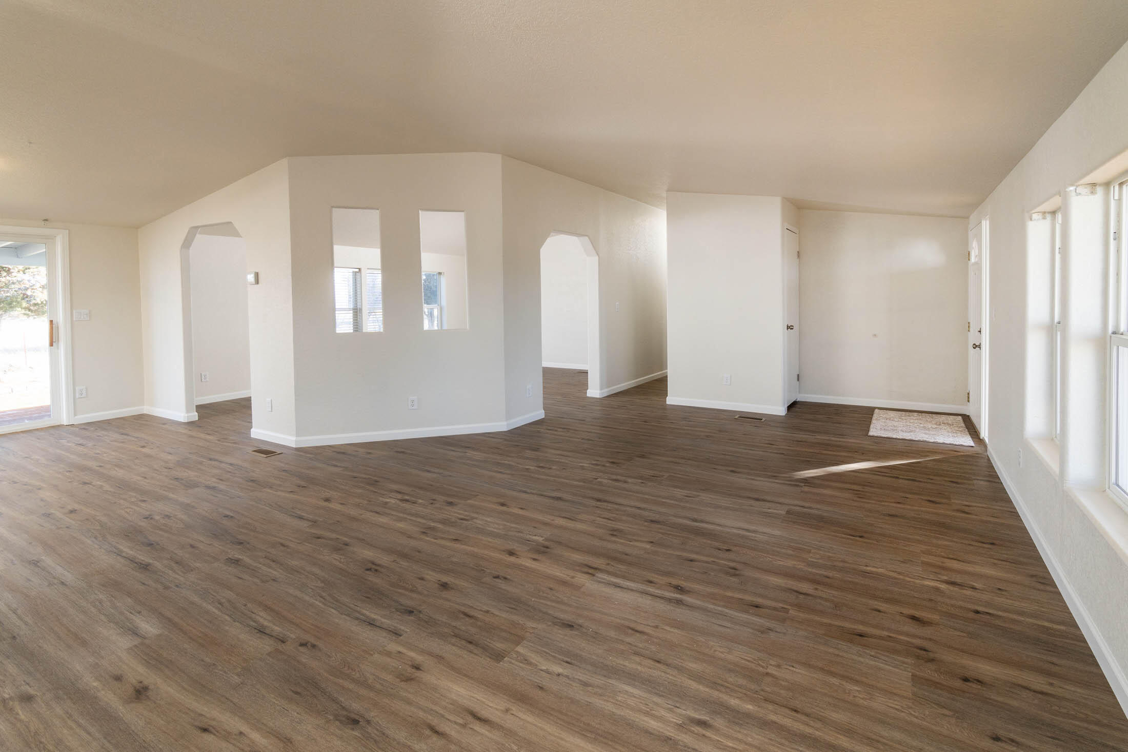 10113 Ridgeview Road Prineville, OR 97754 - Photo 4 of 31 a view of an empty room with wooden floor and a window