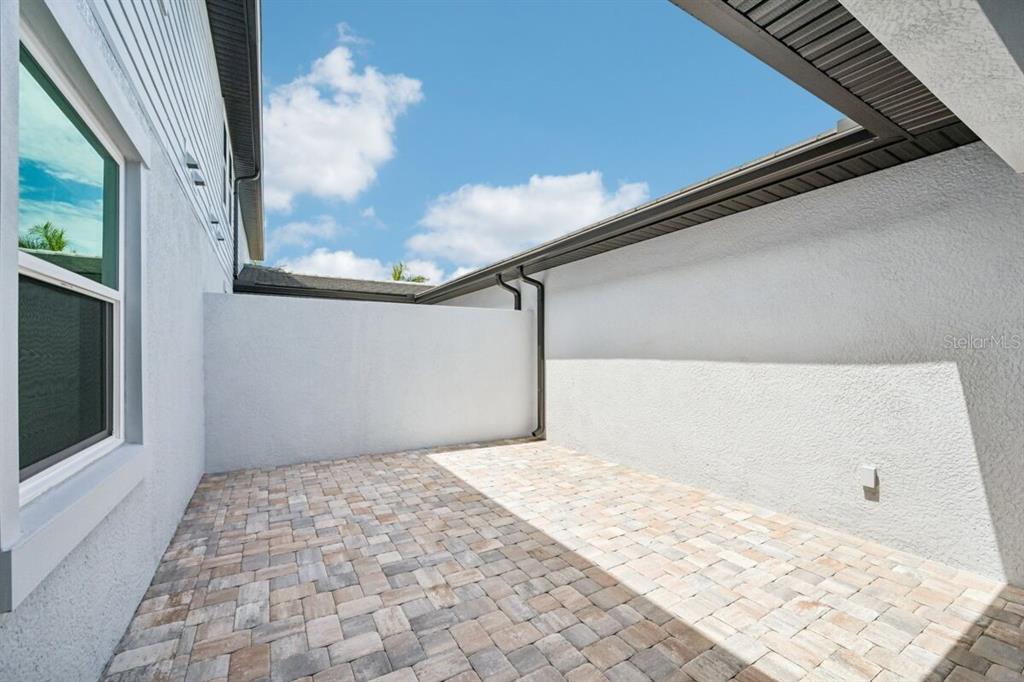 17712 Broadleaf Loop Venice, FL 34293 - Photo 17 of 23 a view of a hallway with a chandelier fan and wooden floor