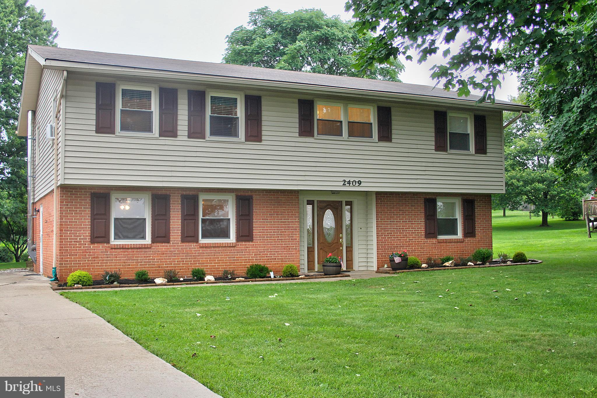 2409 Gillis Road Mount Airy, MD 21771 - Photo 1 of 27 a front view of a house with a garden