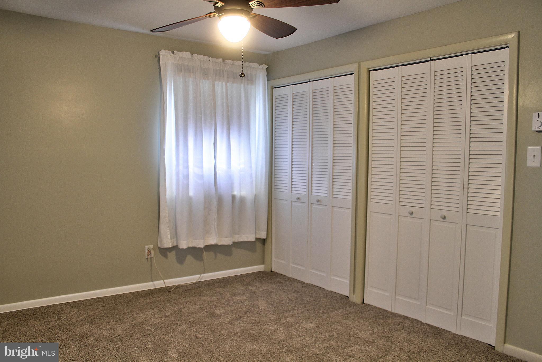 2409 Gillis Road Mount Airy, MD 21771 - Photo 11 of 27 an empty room with a window and a chandelier fan