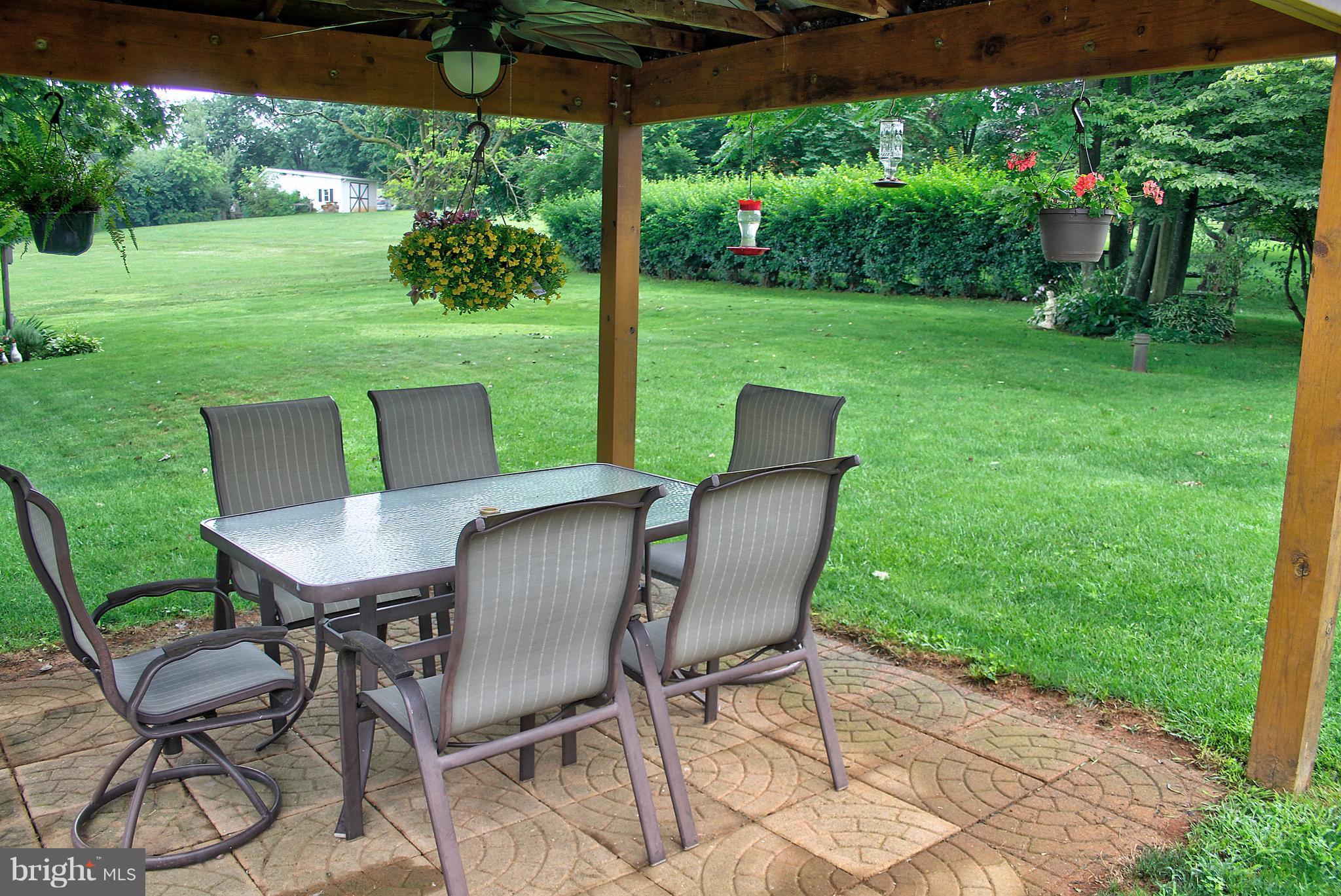 2409 Gillis Road Mount Airy, MD 21771 - Photo 22 of 27 a view of a table and chairs in backyard of the house