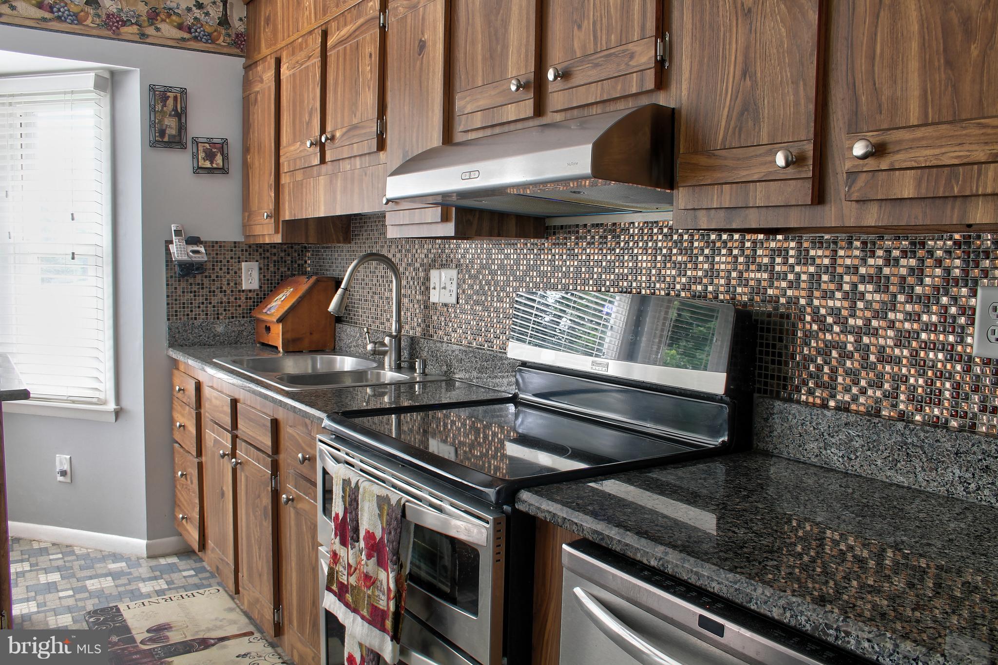 2409 Gillis Road Mount Airy, MD 21771 - Photo 6 of 27 a kitchen with granite countertop a stove and a sink