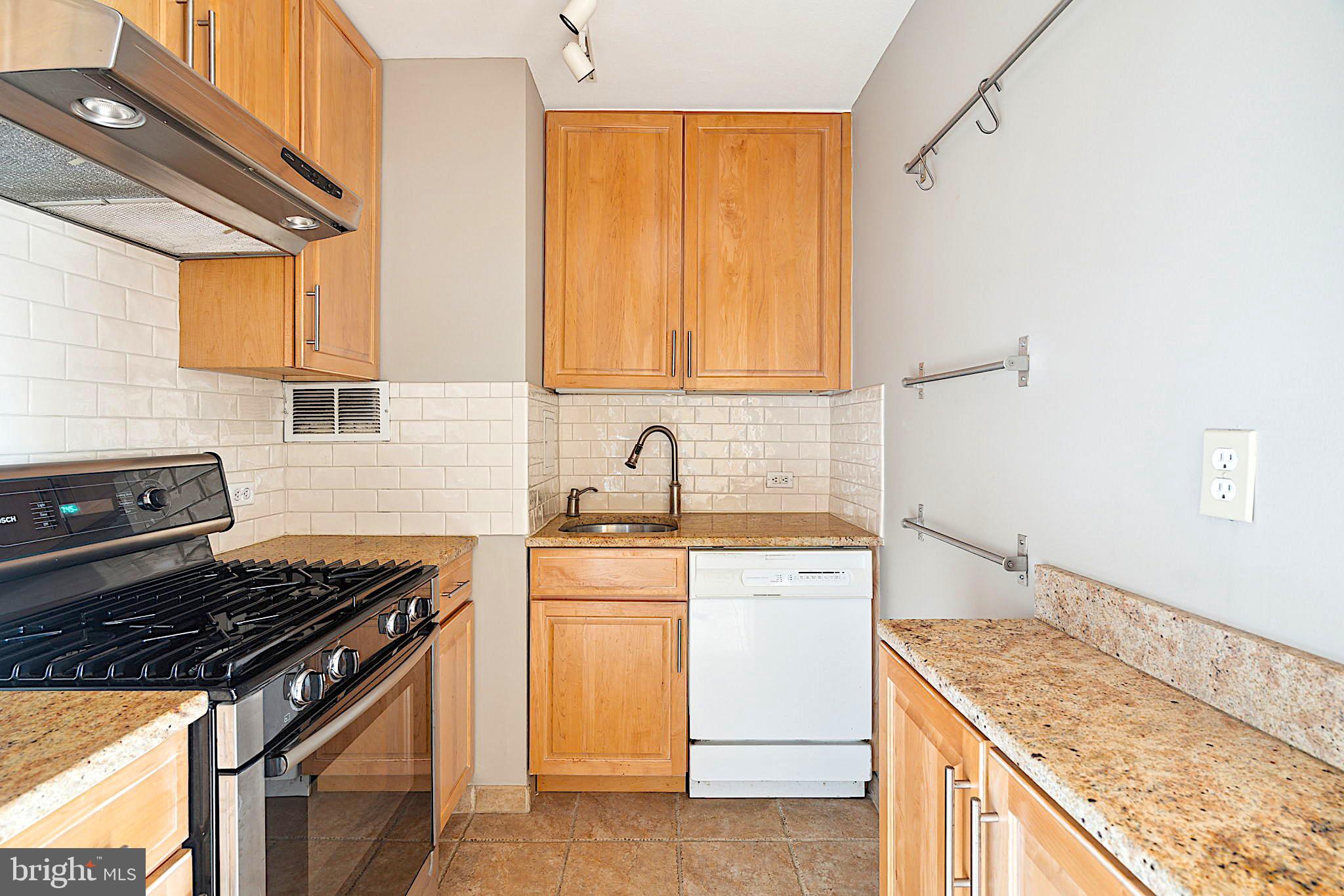 220 Locust Street, Unit 3H Philadelphia, PA 19106 - Photo 13 of 29 a kitchen with a sink stove top oven and cabinets