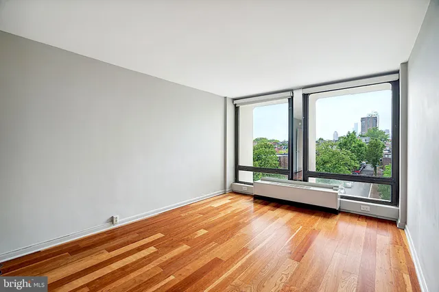 a view of room with window and wooden floor