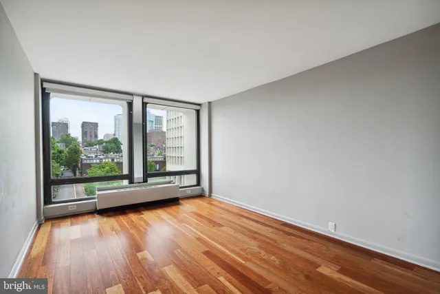 a view of room with window and wooden floor