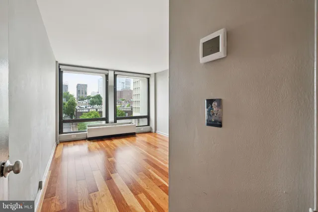 a view of a room with wooden floor and window