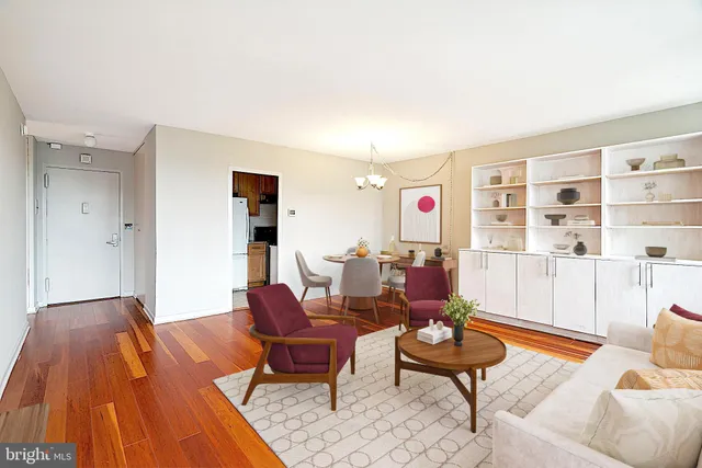 a living room with furniture and a wooden floor