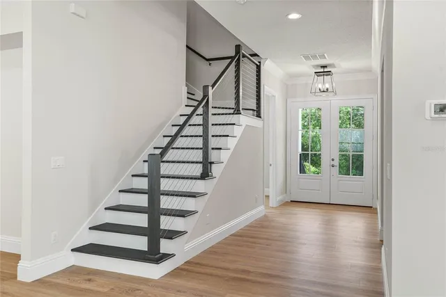a view of entryway with wooden floor and stairs