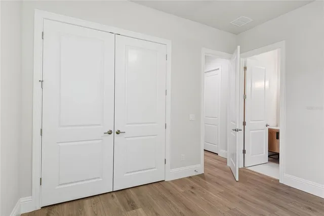 an empty room with wooden floor